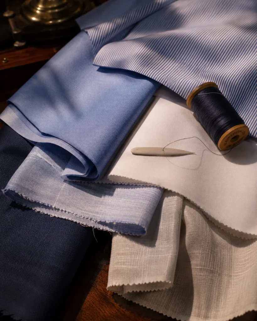 Cotton and linen shirting cloth laid out at Om Fashion Bangkok