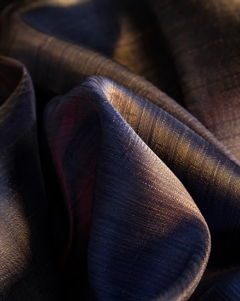 Bolts of genuine Thai silk showing two-tone shimmer at Om Fashion Bangkok